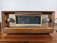 Front view of Fisher FM-80 radio showing full wooden case, dial, knobs, emblem