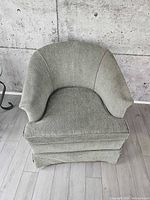 Front view of one green barrel back chair