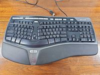 Top view of entire keyboard showing layout, wrist rest, USB cable