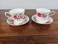 Front view of two tea cups on saucers displaying floral pattern