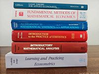 Spines of all six textbooks stacked, showing titles and authors