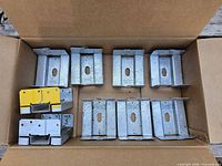 Box containing nine ABA66Z post bases, two partly yellow