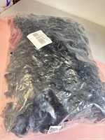 Sealed bag of black plastic bolt-type electric fence insulators
