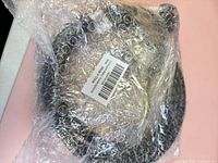 Hose coiled inside bubble wrap with barcode label visible