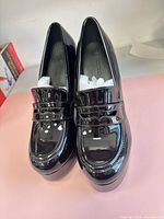 Top view of Coutgo black patent chunky heel shoes showing glossy finish and loafer detail