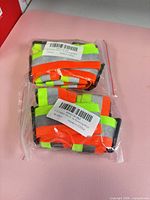 Two sealed packages of reflective bands