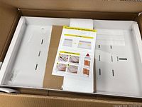 Organizer in box showing white steel tray and hardware