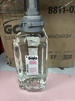 Front view of refill bottle showing label, valve and clear soap