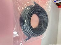Coiled HDMI cable in sealed plastic bag