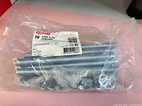 Factory-sealed Hilti bag showing threaded rods, nuts, washers