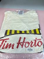 Front of sealed Tim Hortons T-shirt showing logo and graphic