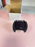 Oil filter wrench cup standing beside opened original white cardboard box