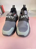 Top view of both safety shoes showing strap with SAFETY text and color details