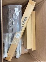 smoker box, rotisserie rods in bubble wrap, Grill Spit box inside carton