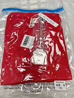 Sealed bag containing folded red cardigan and necklace