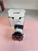 Solenoid standing in front of original box