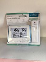 Front of retail package showing console and sensor