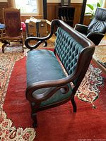 Side angle showing scrolling arm and leg detail
