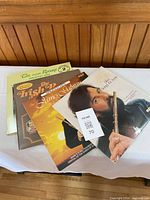 Four LPs fanned out showing covers and MaxSold tag