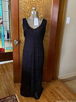 Front view of black lace evening gown on mannequin