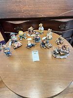 All eleven Boyd's Bears figurines arranged on round table