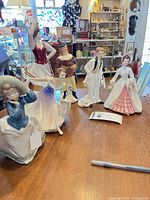 Group shot of six porcelain figurines on table