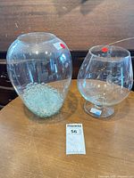 Both glass vases side by side with marbles visible