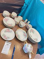 Full lot view showing plates, cups, serving pieces and shakers