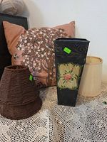 Group shot showing pillow, metal vase, both lamp shades