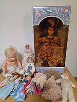 Group shot showing boxed Samantha doll and loose dolls