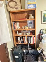 Overall view of shelf contents and luggage