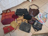 Overview of all handbags and clutches arranged on floor