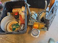 Overall view of tote with assorted tools, cleaner, tool case