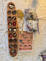 overview of lot showing trays, brooches, earrings, bags of beads, gold-tone chain