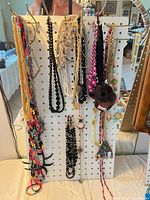 Full pegboard view showing entire assortment of necklaces and bangle