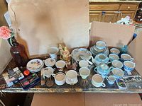 Overall lot view showing china, glassware, figurine, cards and accessories