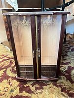 Front view showing wood frame, glass etched doors and overall size