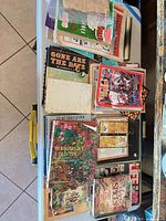 Overview of mixed books and magazines on folding table