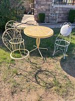 Table and chairs set on lawn showing style, color, condition