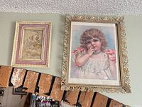 Both framed prints on wall