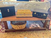 overall view showing coffee table, three boxes on top, basket and Inca box on shelf