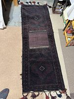 Full view of rectangular Afghan saddlebag rug laid flat