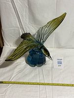 Full view showing seagull wingspan and blue wave base with tape measure for scale