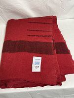 Folded blanket showing color, stripe pattern and point marks