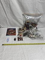 Overall lot with manual, sealed bags, sticker sheet, minifigure and scale