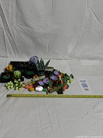 Overall view of assorted assembled succulent models and loose parts with measurement tape