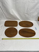 All four teak trays with measuring tape for scale