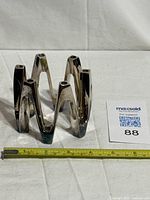 Front view of silver-plated Crown candle holder with tape for scale