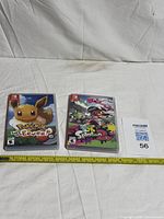 Both Switch games side by side with measuring tape