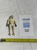 Front view of Stormtrooper figure with measuring tape showing size